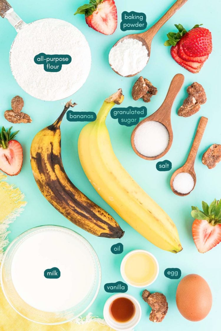 Overhead photo of banana pancake ingredients prepped on a teal surface.