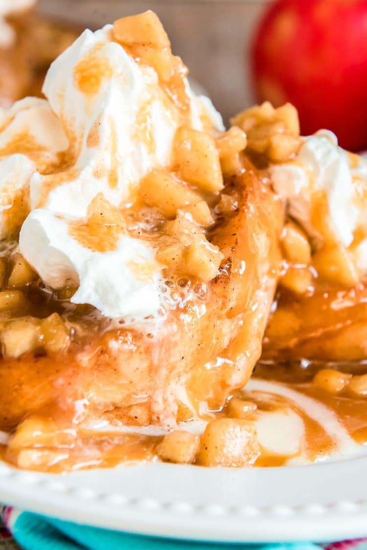 Close up photo of apple french toast on a white plate.