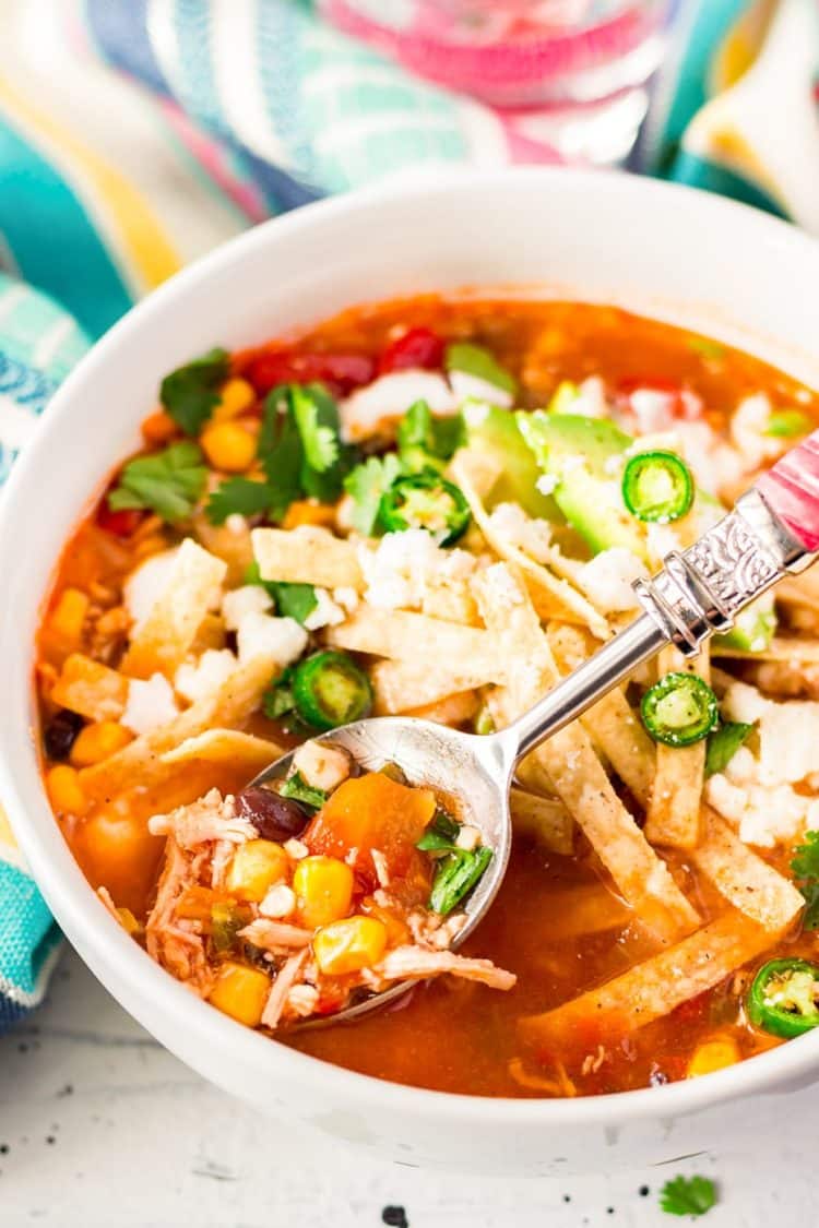  This Slow Cooker Chicken Tortilla Soup is loaded with delicious ingredients like chicken, peppers, tomatoes, corn, and beans and the bold flavor of garlic and cayenne! A comforting and hot meal for chilly nights!