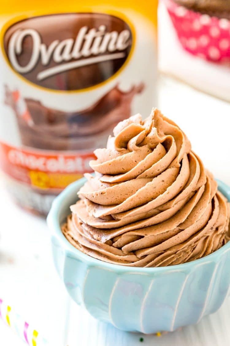 Ovaltine frosting piped into a small blue bowl.