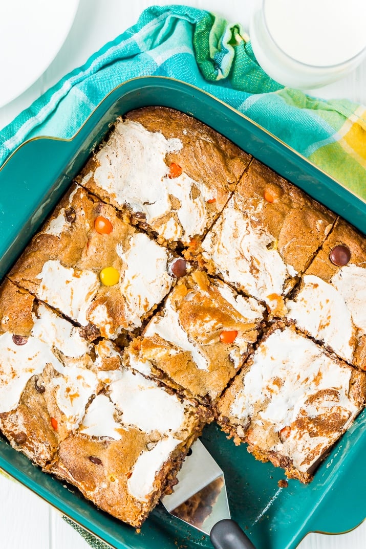 These Peanut Butter Fluff Blondies are a sweet and chewy dessert that's loaded with chocolate chips and Reese's pieces with a marshmallow swirl!