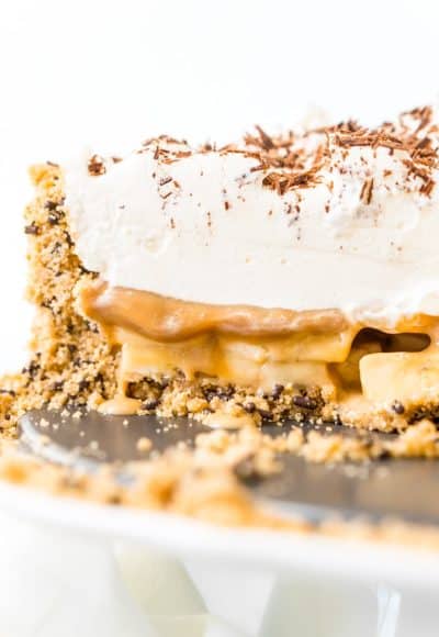 Banoffee Pie is a classic English dessert made with a graham cracker or biscuit crust and loaded with slices of banana, a silky layer of toffee caramel, and a thick layer of freshly whipped cream.