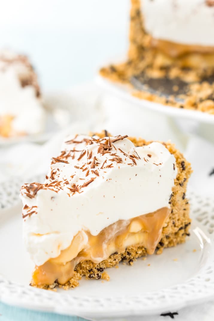 Banoffee Pie is a classic English dessert made with a graham cracker or biscuit crust a loaded with slices of banana, a silky layer of toffee caramel, and a thick layer of freshly whipped cream.