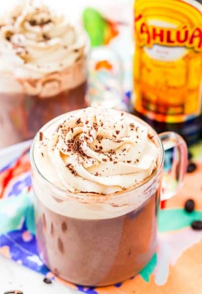 This Kahlua Hot Chocolate is so rich, creamy, and BOOZY! This hot chocolate recipe is laced with coffee liqueur and topped with a Kahlua Whipped Cream and chocolate shavings.