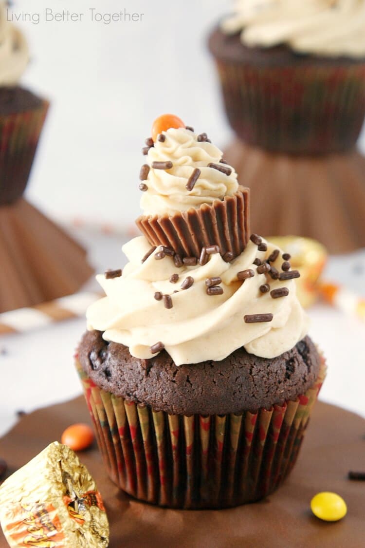 Peanut Butter Surprise Cupcakes - Moist dark chocolate cupcakes filled with a surprise and topped with silky peanut butter buttercream!