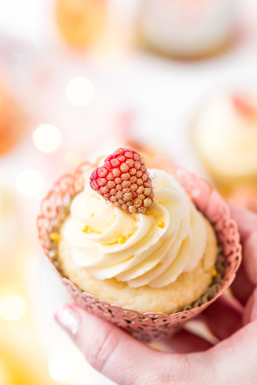 These White Chocolate Raspberry Champagne Cupcakes are perfect for New Year's Eve, Bridal and Baby Showers, and Valentine's Day! Light and fluffy white chocolate cake filled with raspberry filling and topped with a luscious champagne buttercream!