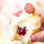 These White Chocolate Raspberry Champagne Cupcakes are perfect for New Year's Eve, Bridal and Baby Showers, and Valentine's Day! Light and fluffy white chocolate cake filled with raspberry filling and topped with a luscious champagne buttercream!