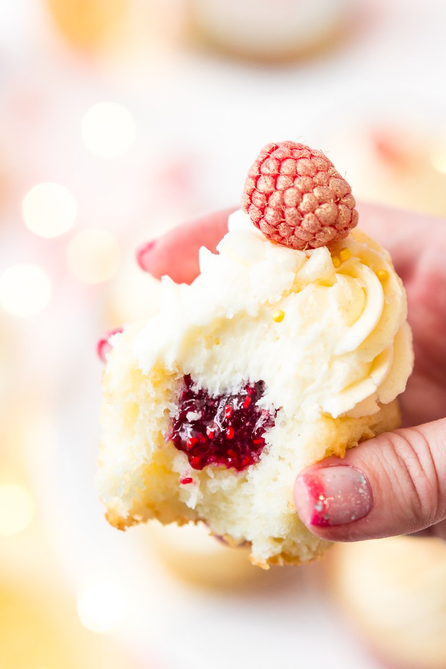 These White Chocolate Raspberry Champagne Cupcakes are perfect for New Year's Eve, Bridal and Baby Showers, and Valentine's Day! Light and fluffy white chocolate cake filled with raspberry filling and topped with a luscious champagne buttercream!