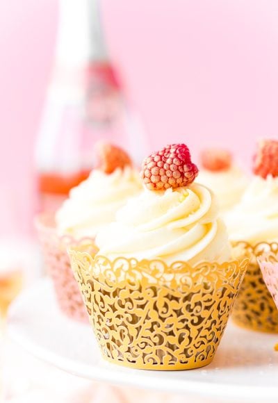 These White Chocolate Raspberry Champagne Cupcakes are perfect for New Year's Eve, Bridal and Baby Showers, and Valentine's Day! Light and fluffy white chocolate cake filled with raspberry filling and topped with a luscious champagne buttercream!