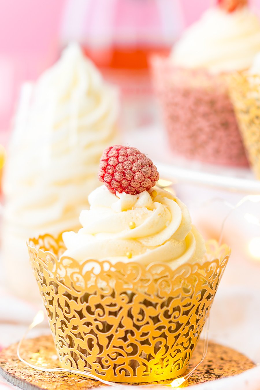 These White Chocolate Raspberry Champagne Cupcakes are perfect for New Year's Eve, Bridal and Baby Showers, and Valentine's Day! Light and fluffy white chocolate cake filled with raspberry filling and topped with a luscious champagne buttercream!