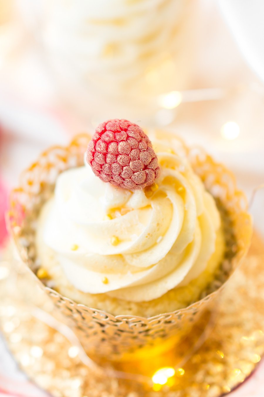 These White Chocolate Raspberry Champagne Cupcakes are perfect for New Year's Eve, Bridal and Baby Showers, and Valentine's Day! Light and fluffy white chocolate cake filled with raspberry filling and topped with a luscious champagne buttercream!