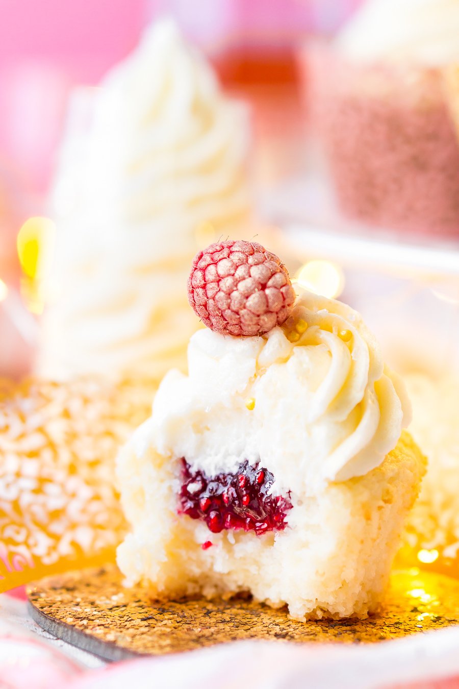 These White Chocolate Raspberry Champagne Cupcakes are perfect for New Year's Eve, Bridal and Baby Showers, and Valentine's Day! Light and fluffy white chocolate cake filled with raspberry filling and topped with a luscious champagne buttercream!