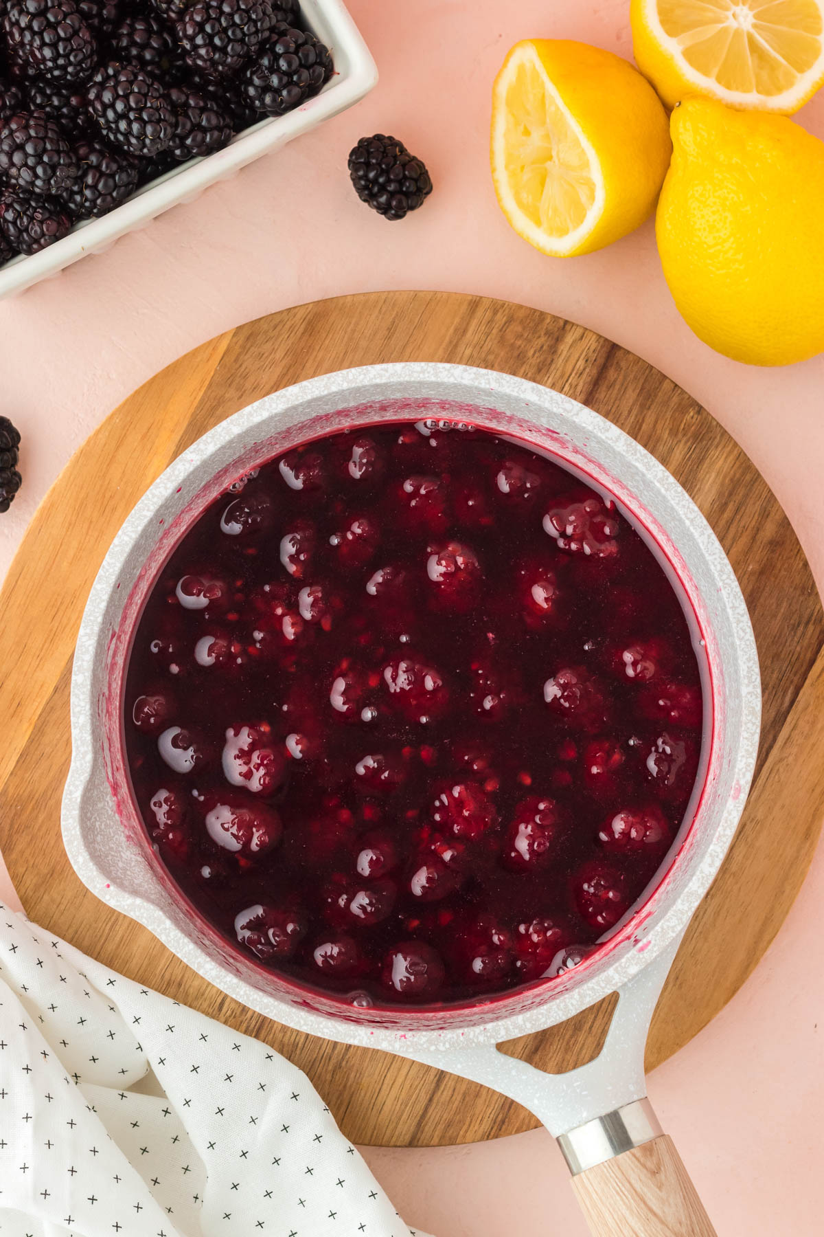 Overhead photo of a pot of blackberry simple syrup simmering.