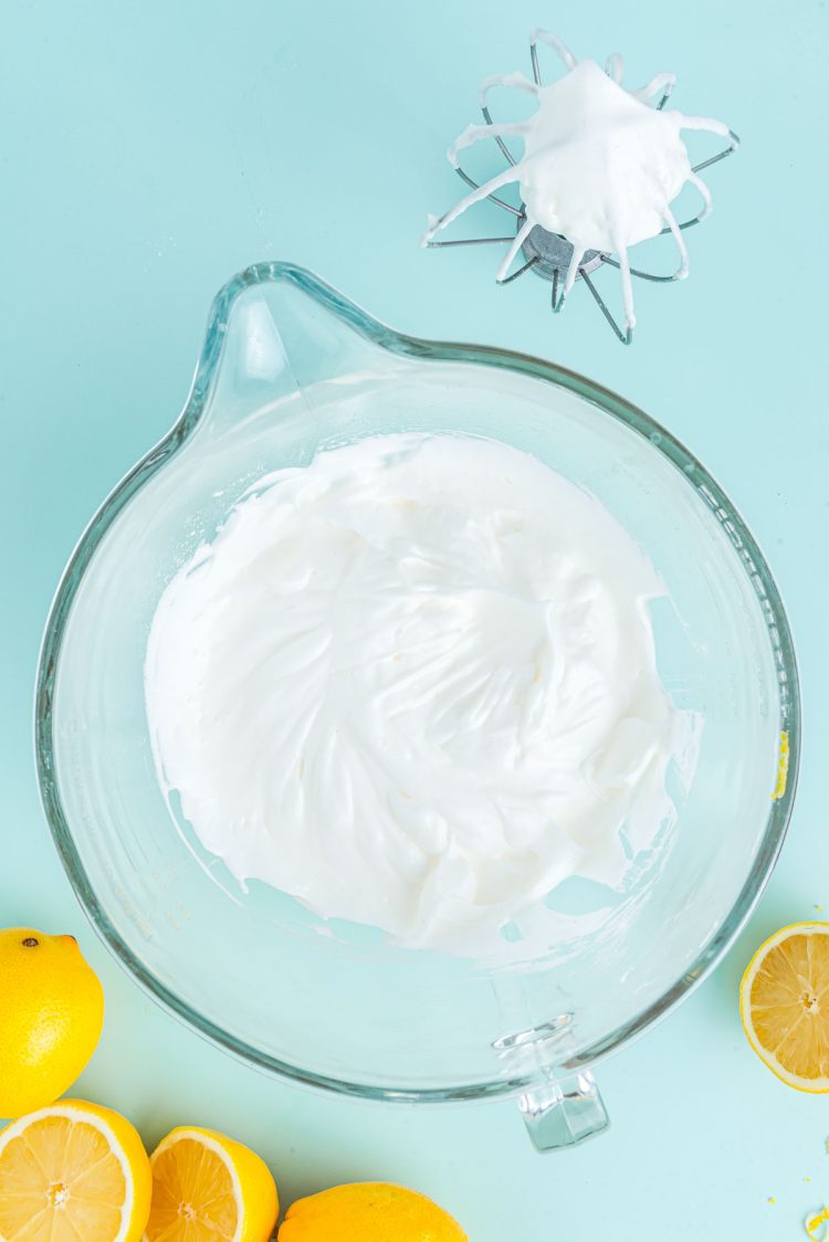 Meringue in a glass mixing bowl.