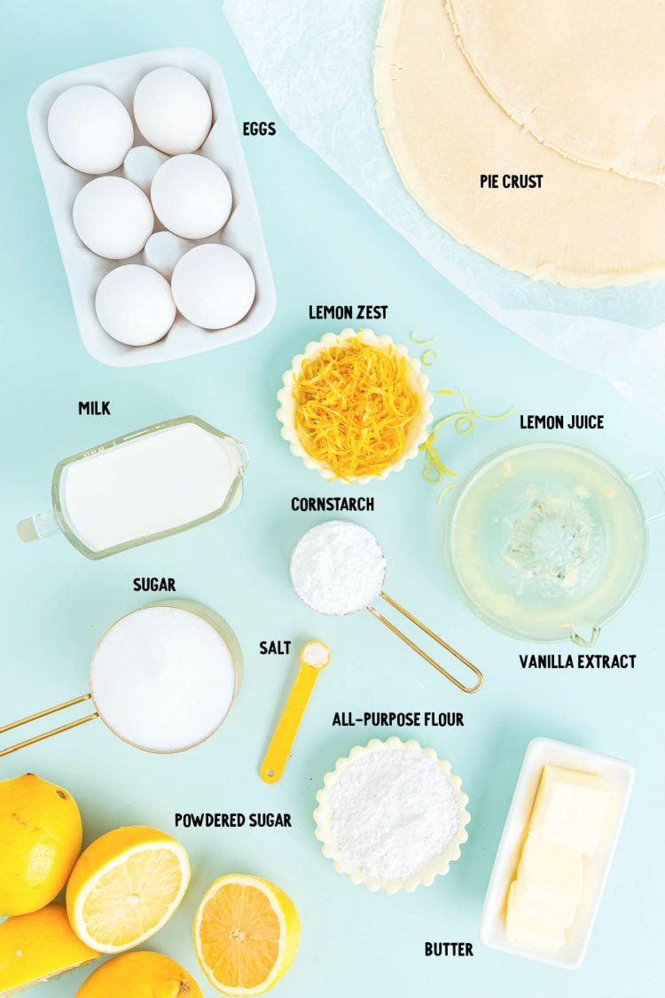 Ingredients to make lemon meringue slab pie prepped on a blue table.