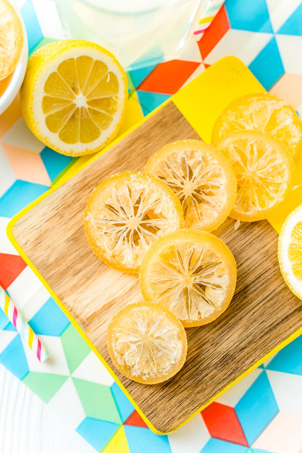 Overhead photo of candied lemon slices on a cutting board.