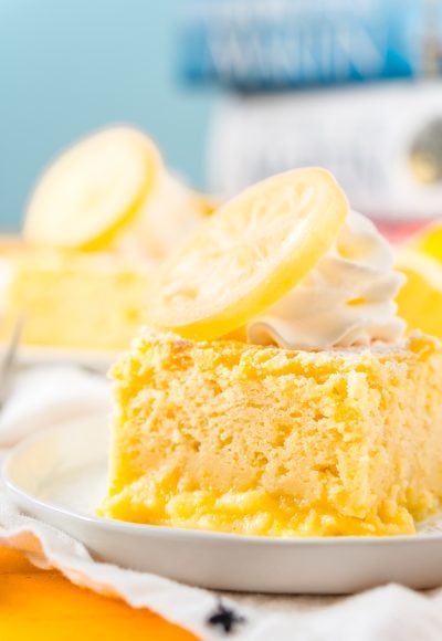 Close up photo of a slice of lemon cake on a small white plate.