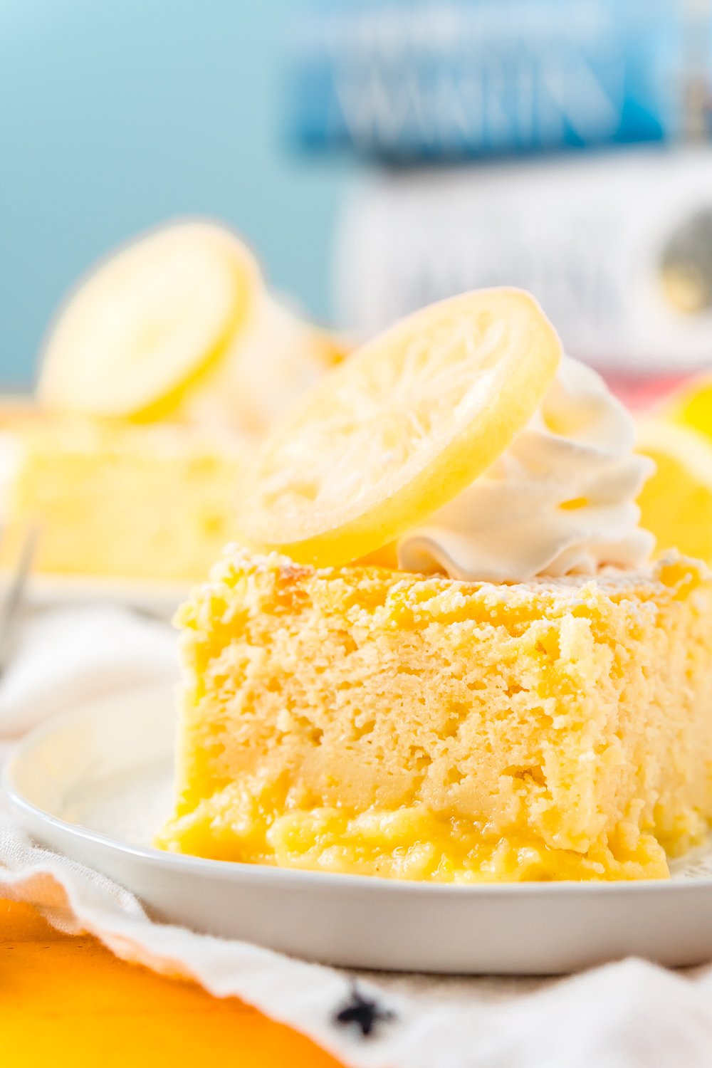 Close up photo of a slice of lemon cake on a small white plate.