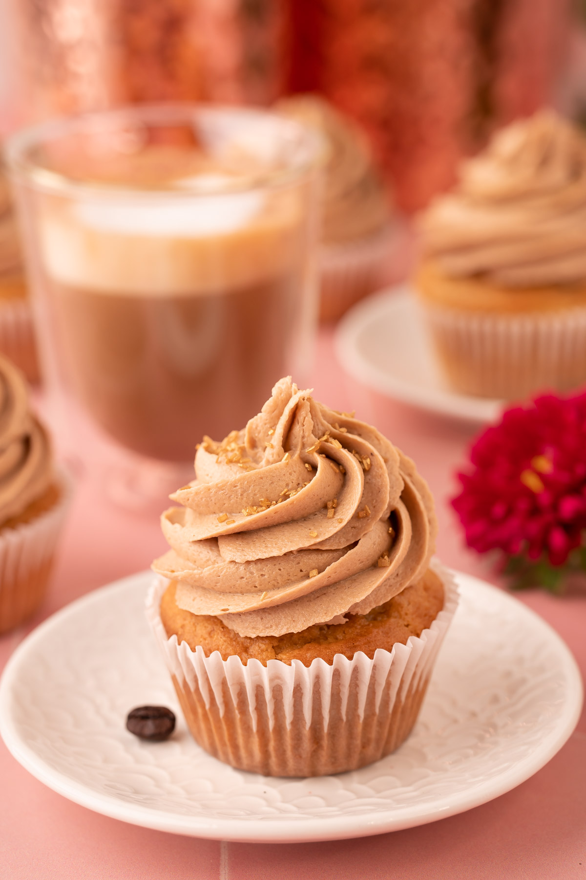 A French Vanilla Cupcake on a white plate.