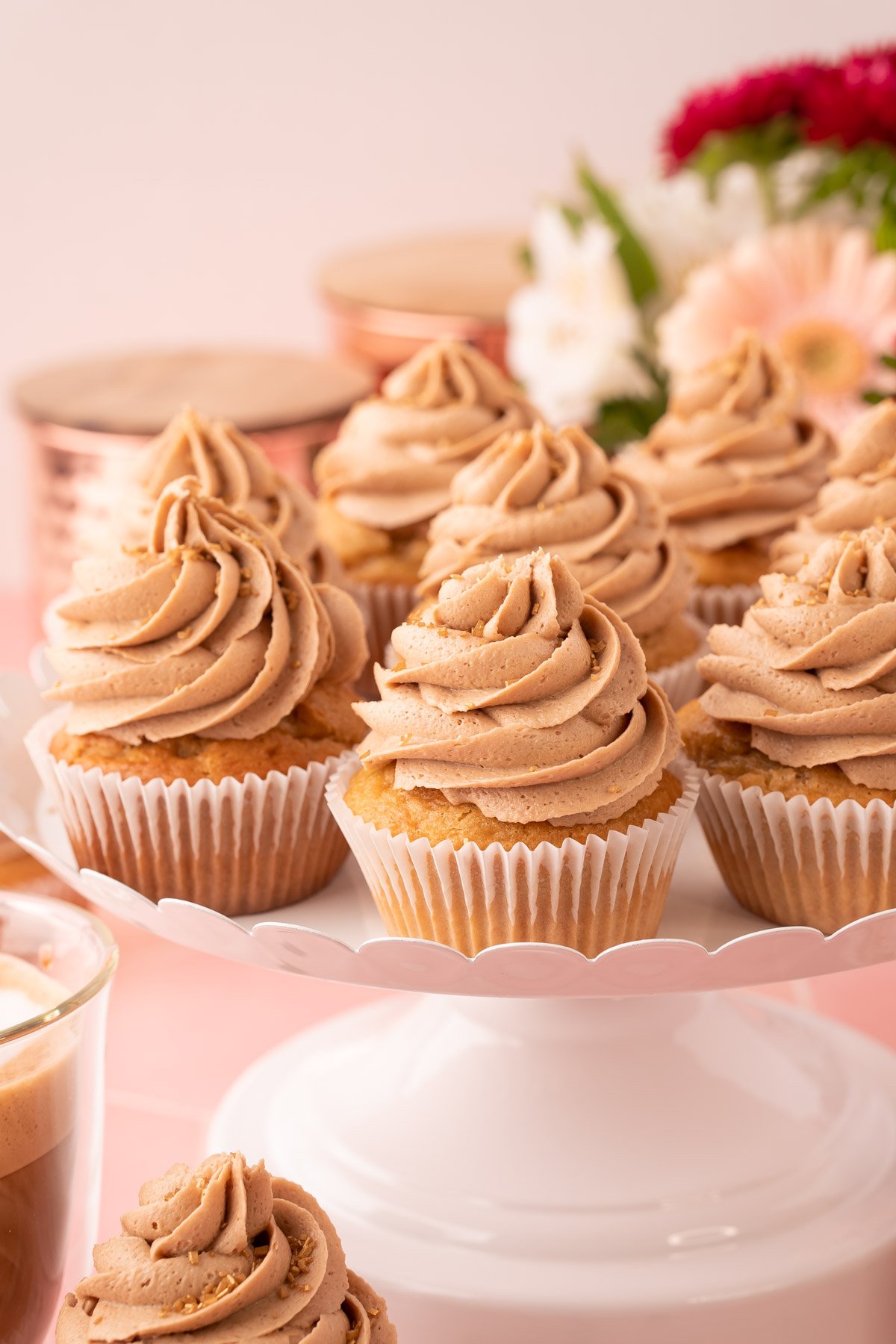 French Vanilla Cappuccino Cupcakes on a white cake stand.