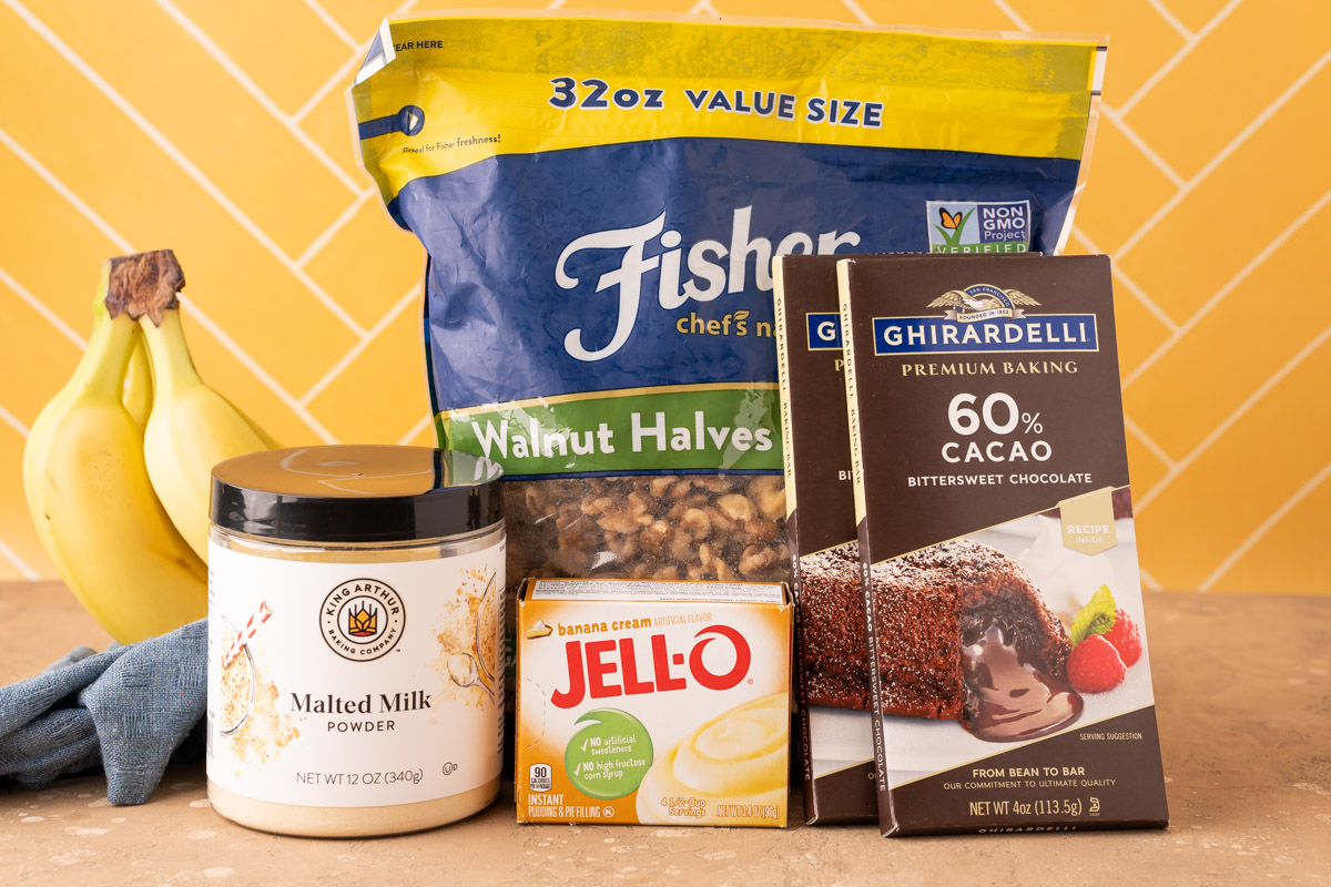 Key ingredients to make chunky monkey pudding cookies on a table.