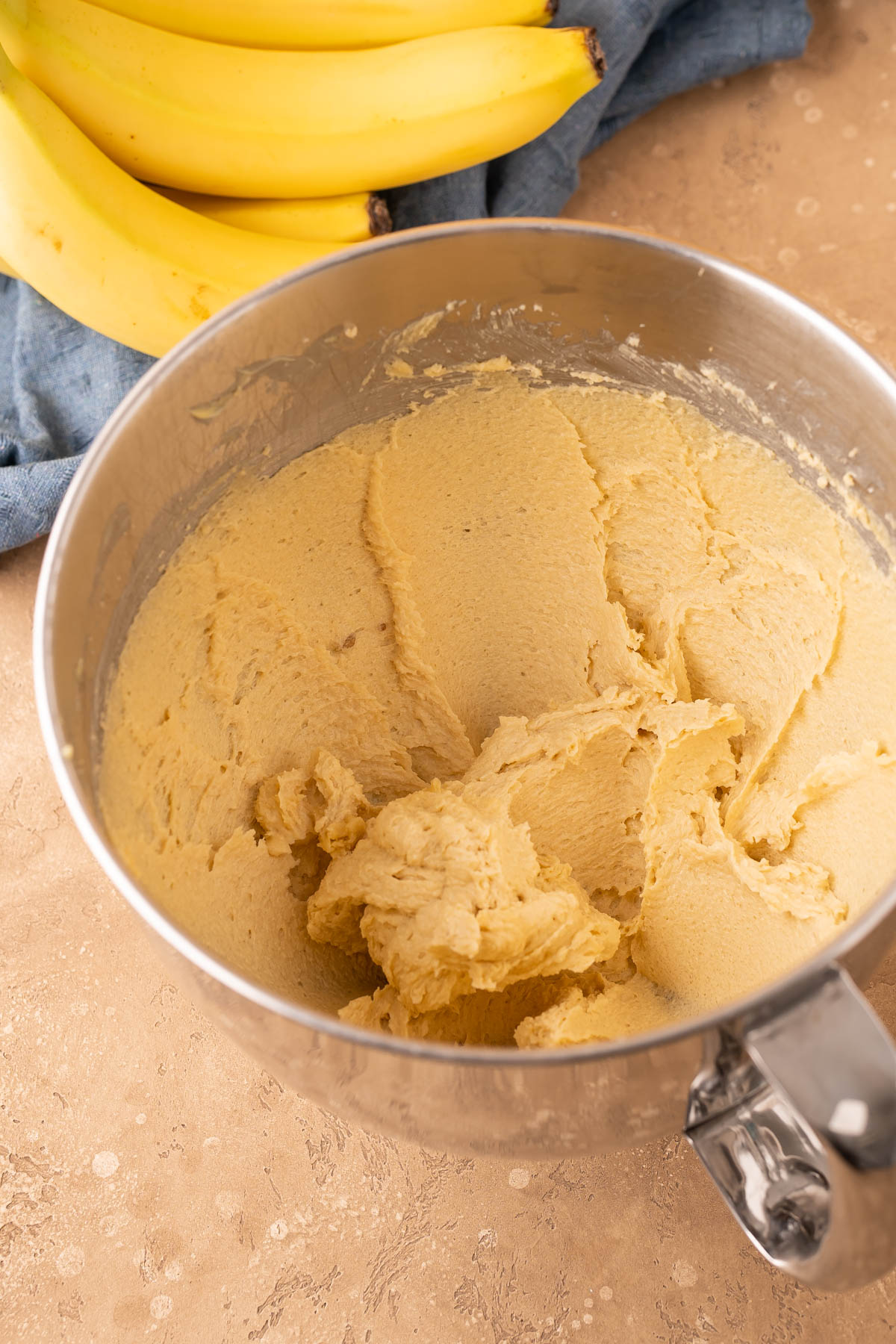 Butter and sugar that's been creamed in a stand mixer bowl.