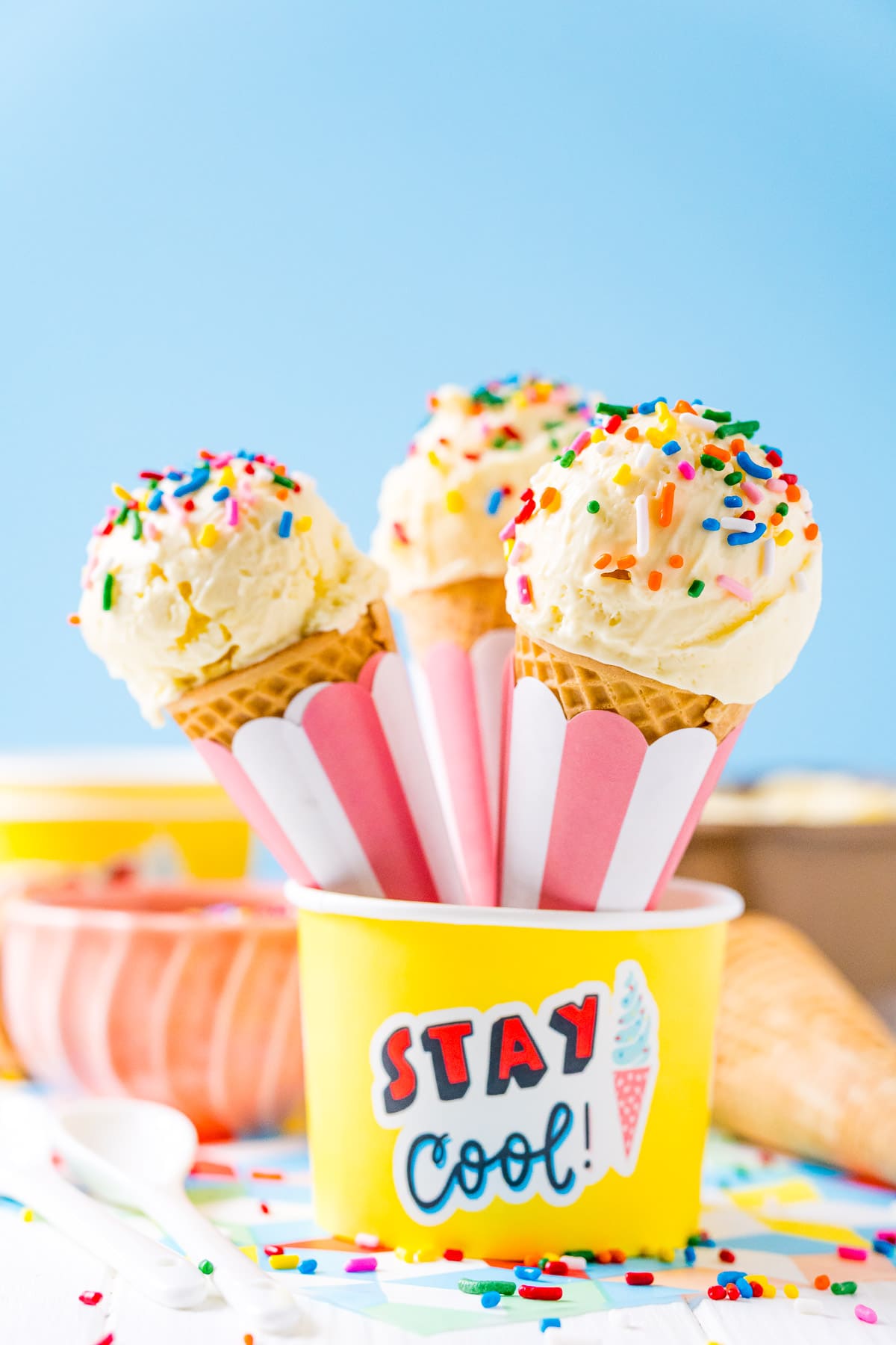 Ice Cream cones resting in a yellow bowl.