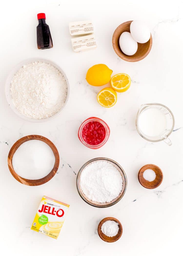 Overhead photo of ingredients to make strawberry lemon cupcakes prepped on a marble counter.