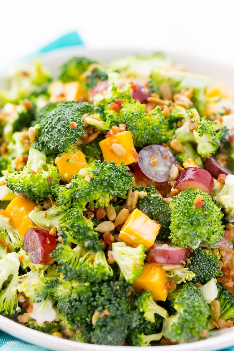 This Sweet Broccoli Salad is an easy, crunchy, and lightly sweetened side salad that's perfect for BBQs and more! Made with fresh broccoli, grapes, cheese, sunflower seeds, bacon, and a delightful dressing! Bring it to all your summer get-togethers!