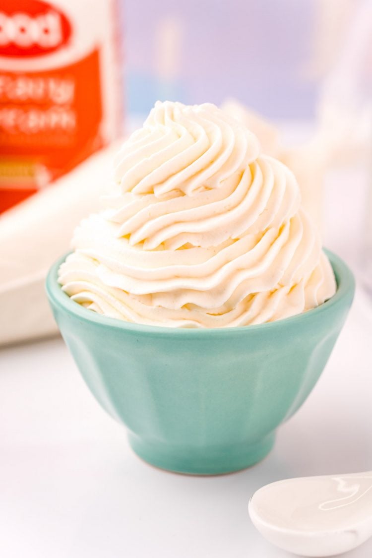 Close up photo of a light blue bowl that has whipped cream piped into it.