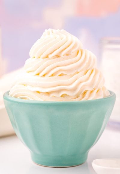 Close up photo of a light blue bowl that has whipped cream piped into it.