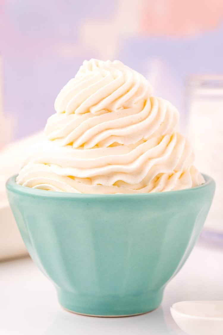 Close up photo of a light blue bowl that has whipped cream piped into it.