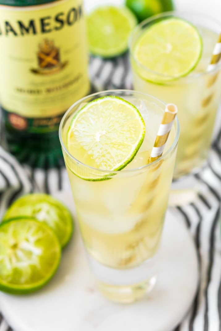 A glass with an irish mule cocktail in it garnished with a lime slice.