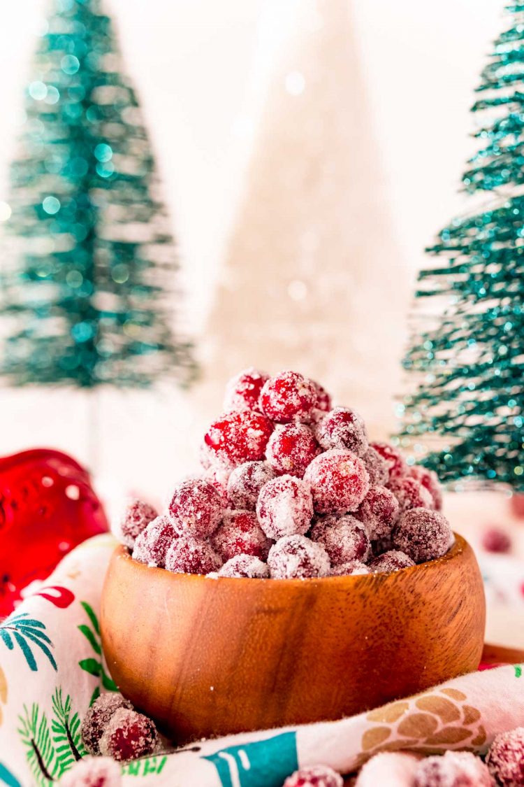 Sugared cranberries in a wooden bowl.