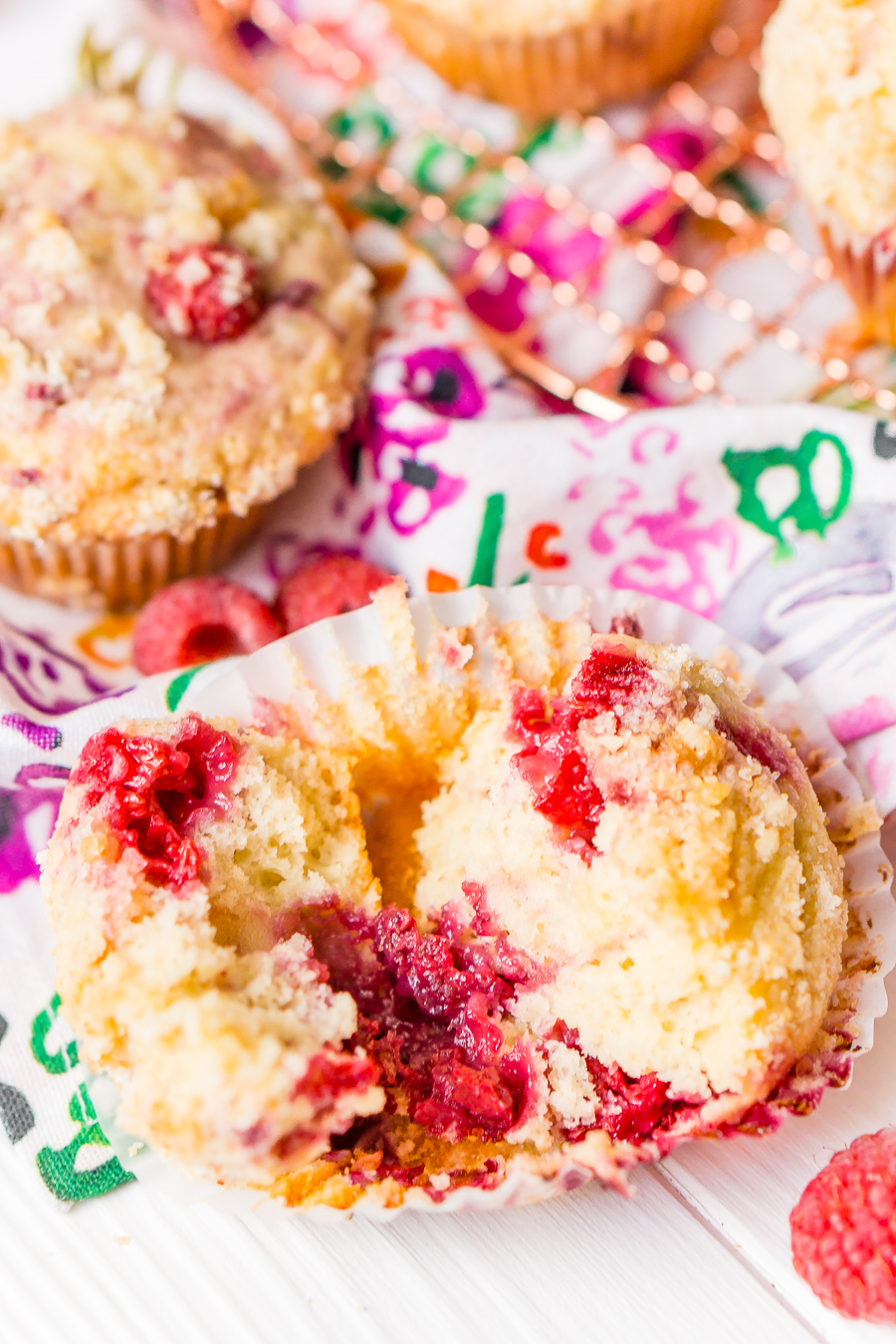 Raspberry Muffins loaded with juicy red raspberries and topped with an irresistible sugar crumble.