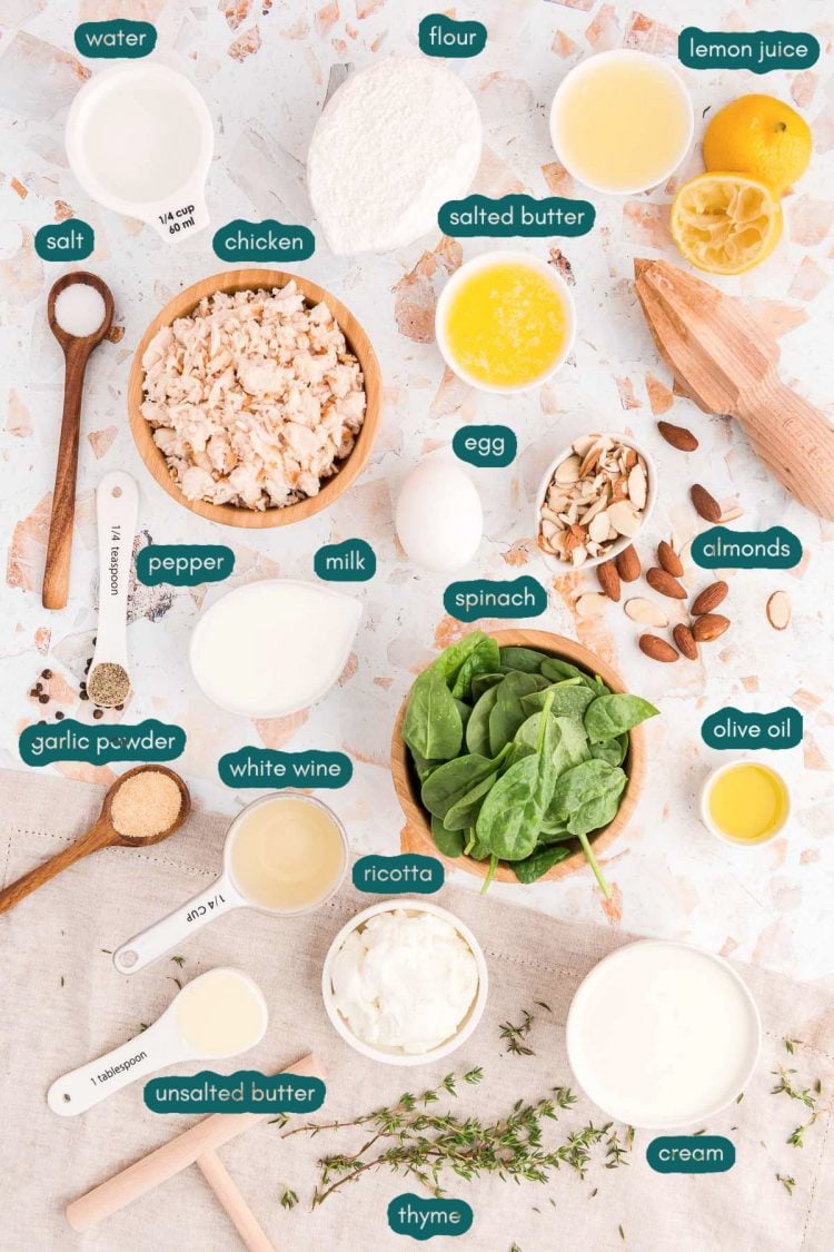 Overhead photo of ingredients prepped to make spinach and chicken crepes on a countertop.