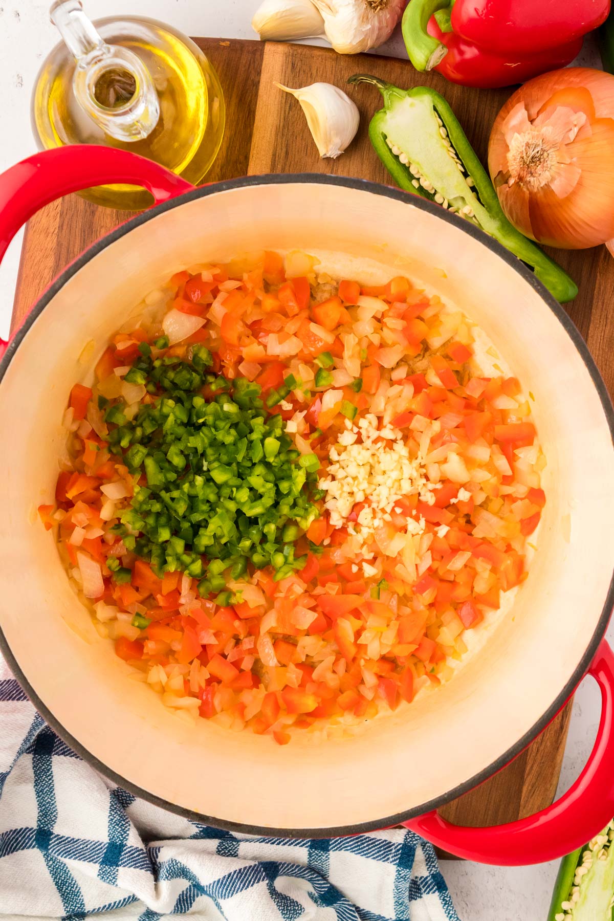 peppers and onions sauteed in a dutch oven with garlic added to start making chili.