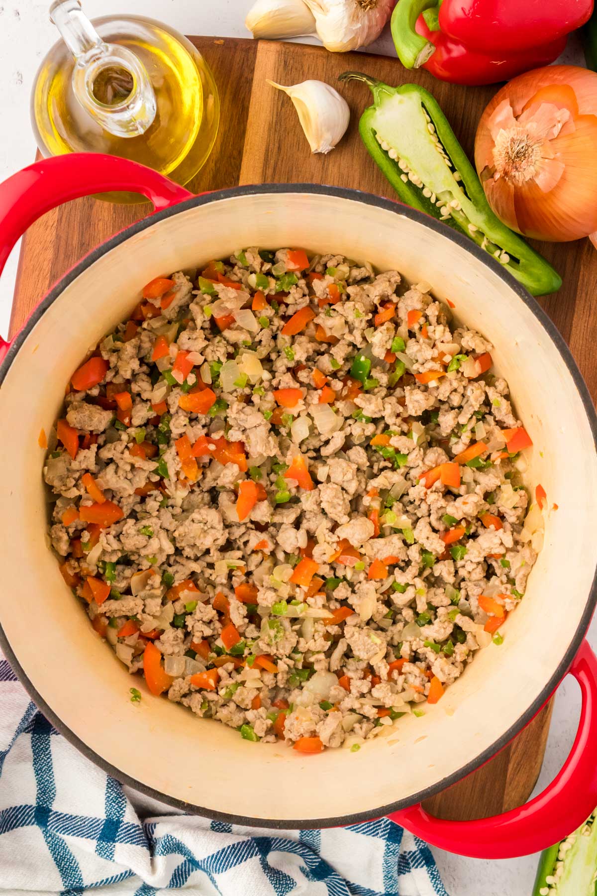 Ground turkey and veggies being cooked in a dutch oven.