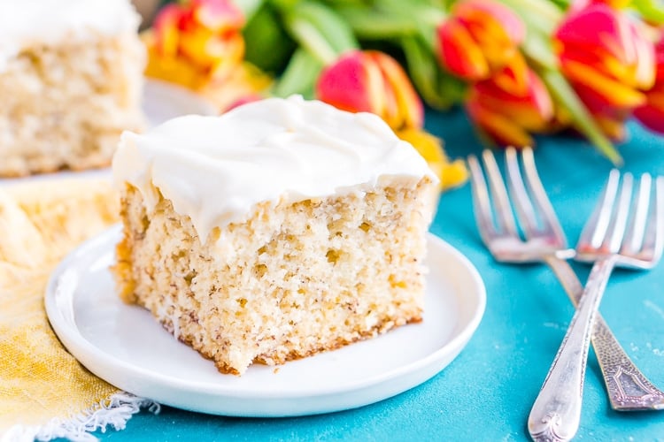 This is the Best Banana Cake recipe EVER! It's moist and sweet and topped with a tangy cream cheese frosting!