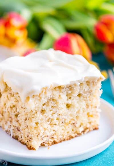 This is the Best Banana Cake recipe EVER! It's moist and sweet and topped with a tangy cream cheese frosting!