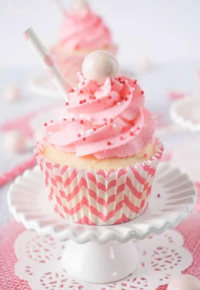 These Strawberry Milkshake Cupcakes have a vanilla malt base and are topped with a strawberry milk whipped cream frosting, sprinkles, and a whopper! Make them for an instant trip down memory lane.