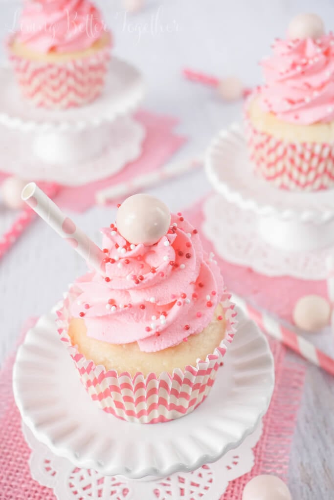 These Strawberry Milkshake Cupcakes have a vanilla malt base and are topped with a strawberry milk whipped cream frosting, sprinkles, and a whopper! Make them for an instant trip down memory lane.