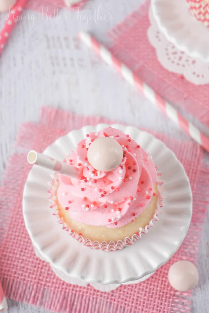 These Strawberry Milkshake Cupcakes have a vanilla malt base and are topped with a strawberry milk whipped cream frosting, sprinkles, and a whopper! Make them for an instant trip down memory lane.