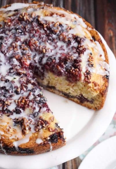 This Triple Berry Coffee Cake is loaded with strawberries, blueberries, and blackberries then finished off with chopped pecans and a simple icing.