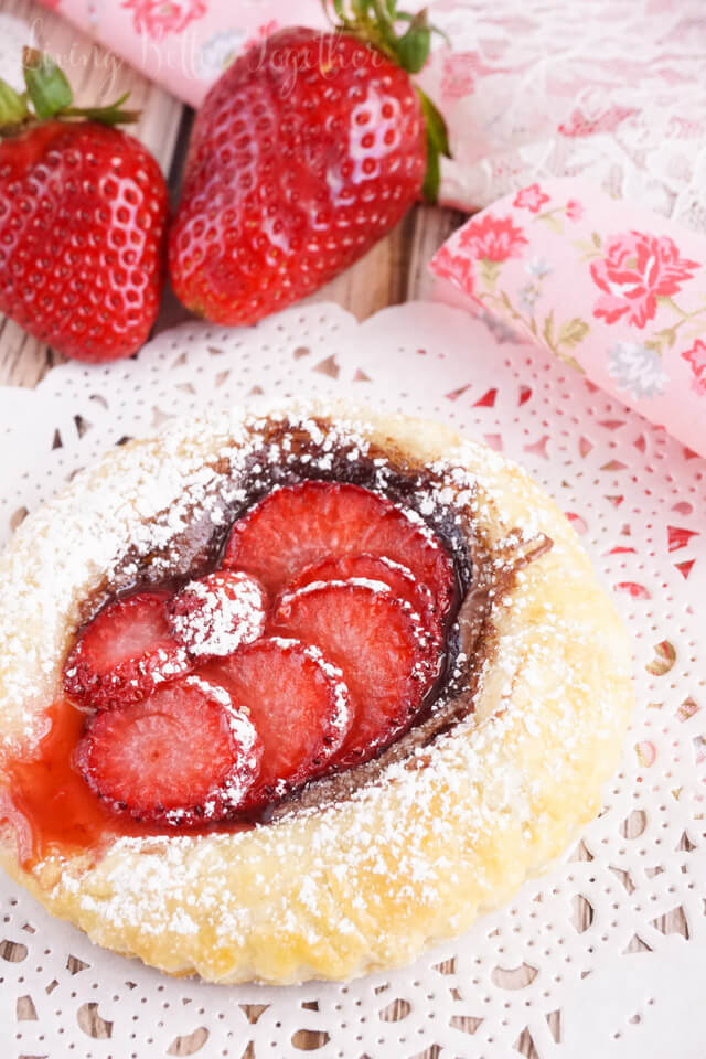 These Strawberry Nutella Tarts inspired by The Selection Series are so simple to make. Rich and creamy Nutella and tart strawberries in a flaky pastry dusted in sugar - they're absolutely divine!