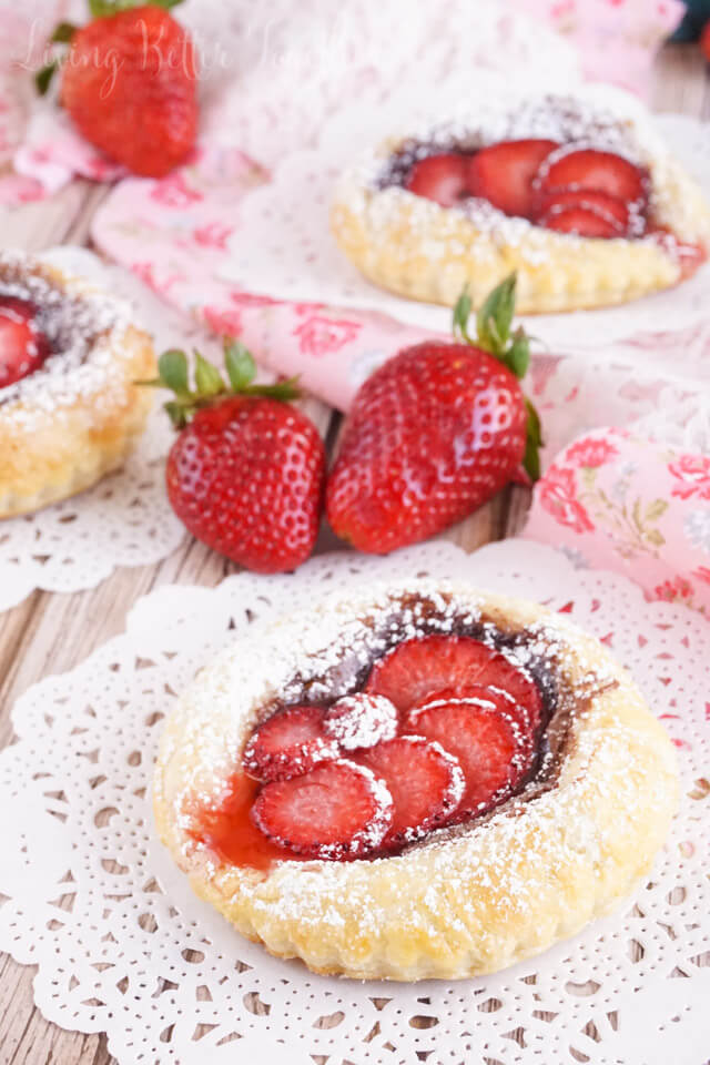 These Strawberry Nutella Tarts inspired by The Selection Series are so simple to make. Rich and creamy Nutella and tart strawberries in a flaky pastry dusted in sugar - they're absolutely divine!