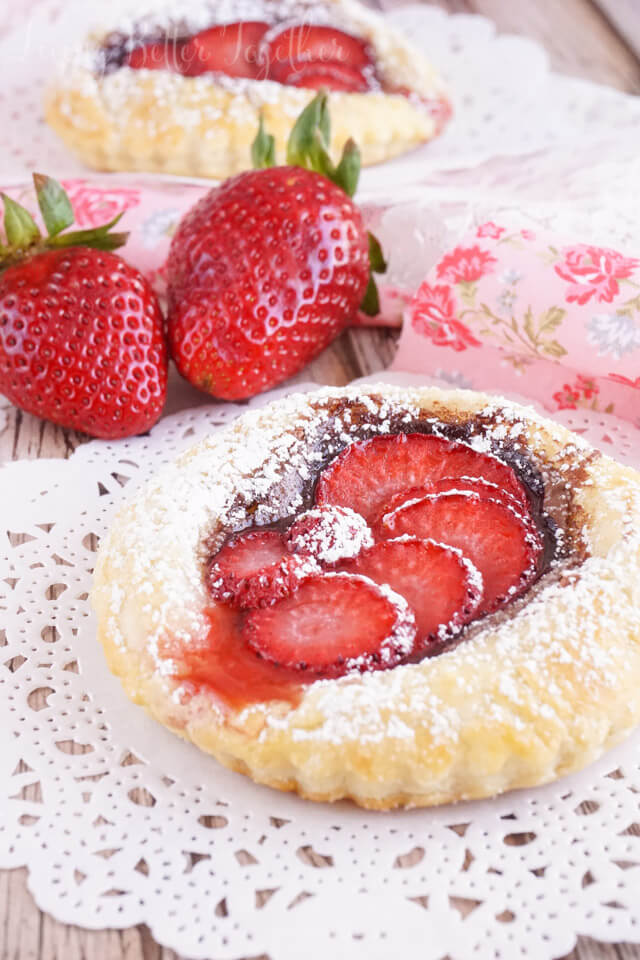 These Strawberry Nutella Tarts inspired by The Selection Series are so simple to make. Rich and creamy Nutella and tart strawberries in a flaky pastry dusted in sugar - they're absolutely divine!