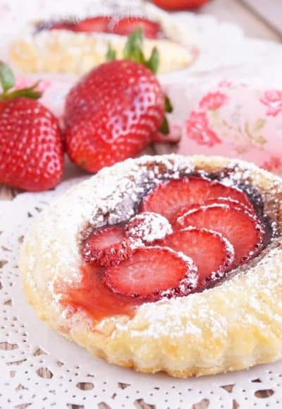 These Strawberry Nutella Tarts inspired by The Selection Series are so simple to make. Rich and creamy Nutella and tart strawberries in a flaky pastry dusted in sugar - they're absolutely divine!