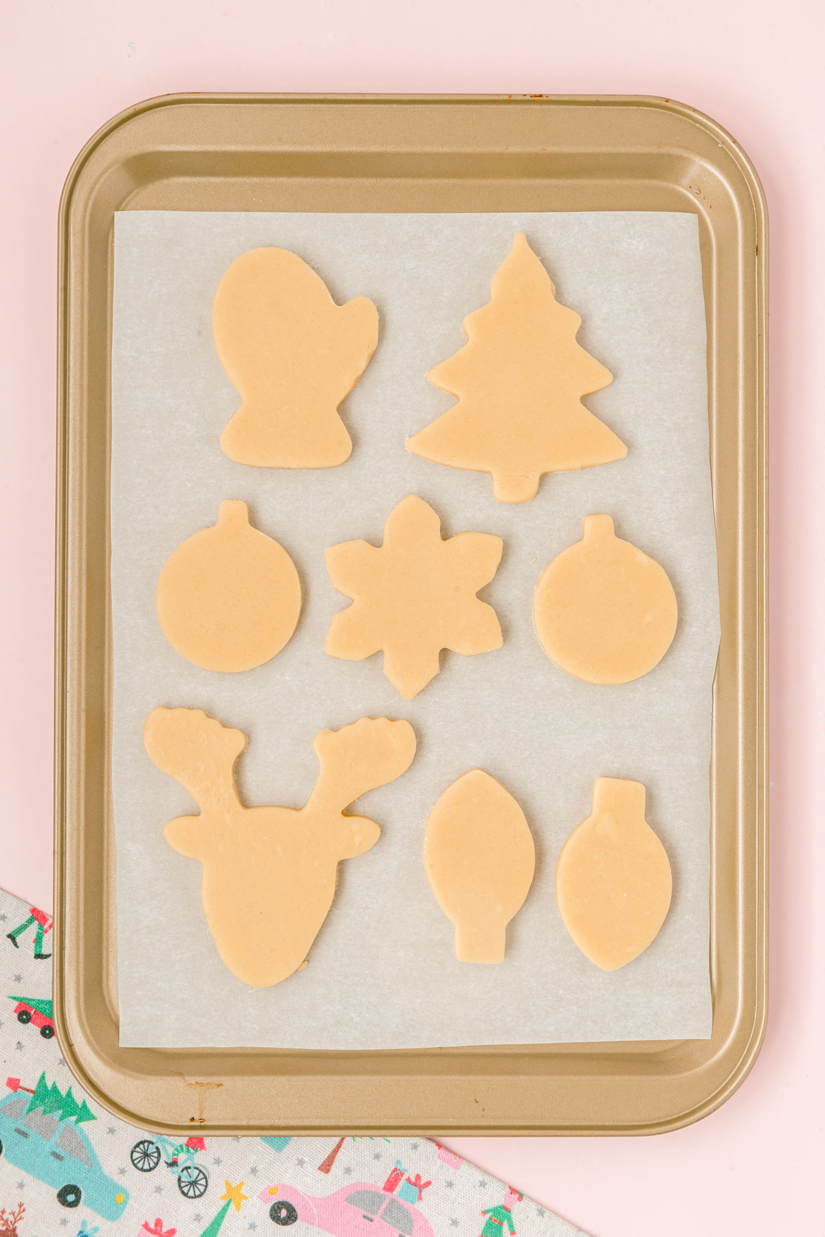 Cut out sugar cookies on a baking pan ready to bake.