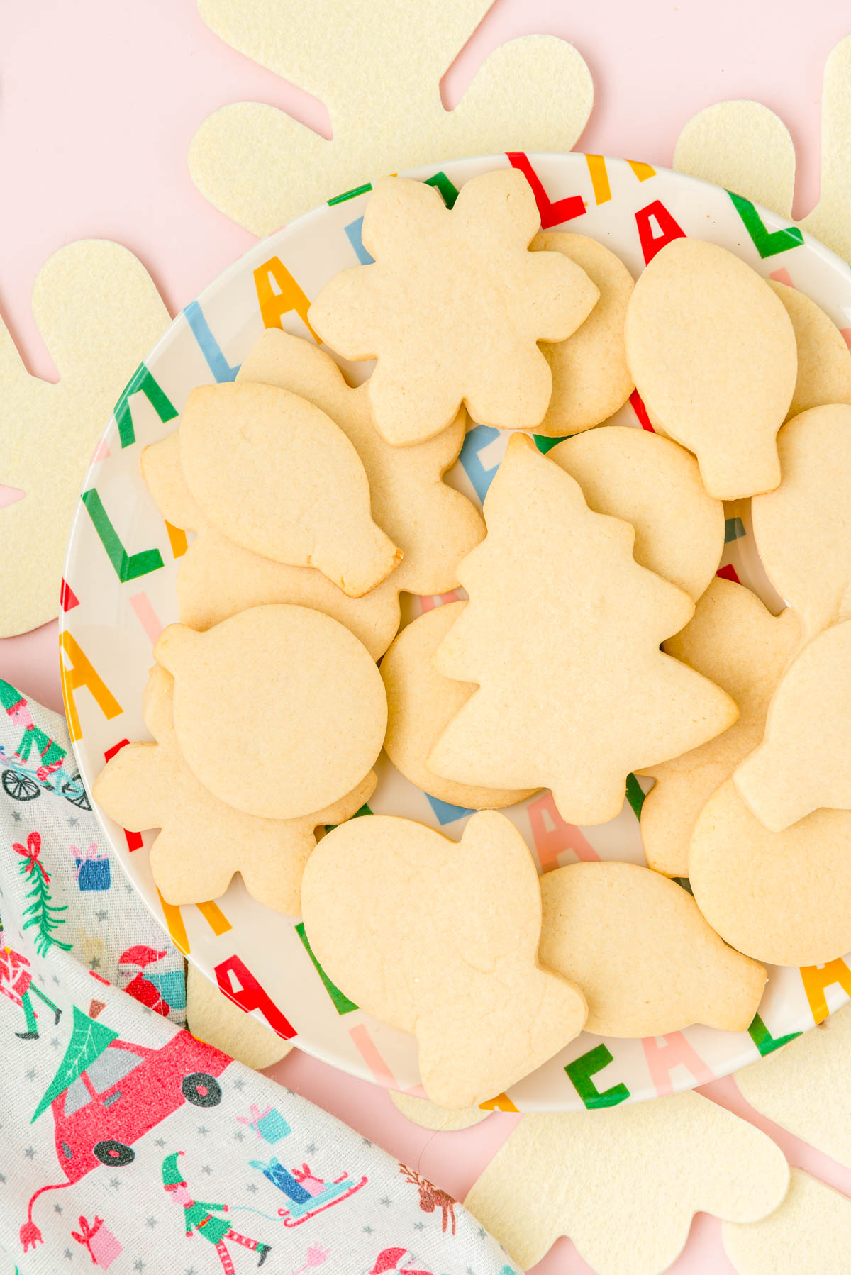 Overhead photo of unfrosted sugar cookies on a plate.